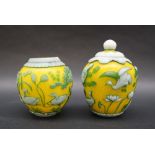 A pair of Chinese overlay jars and cover, with a yellow ground, carp fisherman, ducks etc,