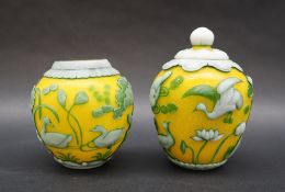 A pair of Chinese overlay jars and cover, with a yellow ground, carp fisherman, ducks etc,