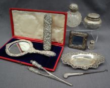An Edward VII silver and velvet hand mirror decorated with flowerheads and scrolls, Birmingham,