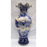 A Japanese blue and white porcelain vase decorated with a raised dragon encircling the vase further