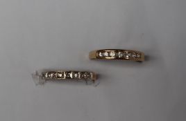 A 9ct gold half eternity ring set with nine round brilliant cut diamonds to a white metal mount and