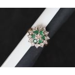 A 9ct gold emerald and diamond cluster ring, set with six emeralds and two tiers of diamonds,