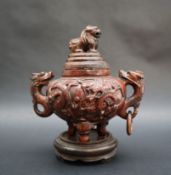 A Chinese hardstone urn and cover with a dog of foo finial,