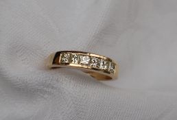 Gemporia - An 18ct gold diamond line ring,