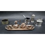 An Elizabeth II miniature silver five piece teaset with a tray, hot water pot, teapot,