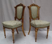 A pair of French gilt decorated bedroom chairs,