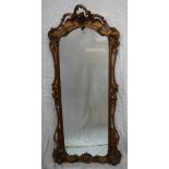 A French giltwood and gesso three quarter length mirror with a carved and pierced cresting,