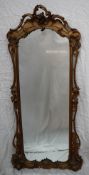 A French giltwood and gesso three quarter length mirror with a carved and pierced cresting,