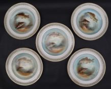 A set of five pottery plates decorated with fish, signed Austin,