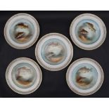 A set of five pottery plates decorated with fish, signed Austin,