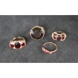 A 9ct gold ring set with three oval faceted garnets,