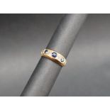 A sapphire and diamond ring set with three round faceted sapphires and two round old cut diamonds
