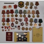 A collection of Russian medals, pin badges and coins,