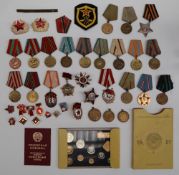 A collection of Russian medals, pin badges and coins,