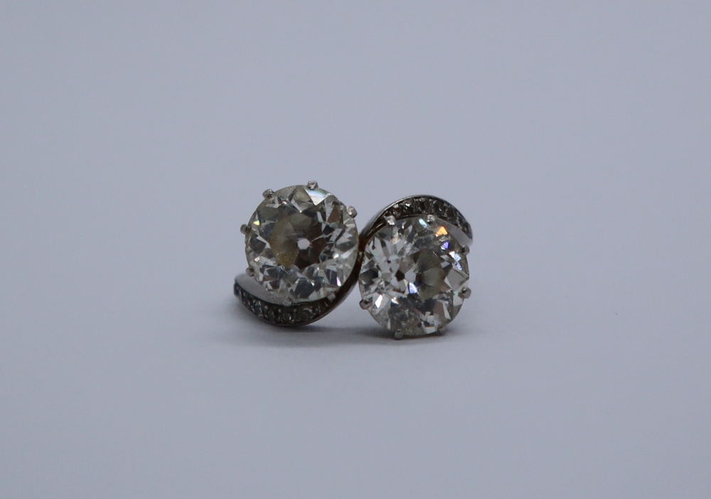 A two stone diamond ring, each old round cut diamond approximately 2.