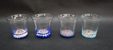 A set of four liqueur glasses set with paperweights to the base,