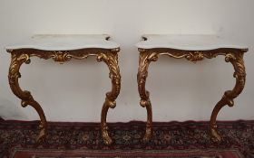 A pair of French marble and carved gilt wood pier tables, the white marble tops of serpentine form,