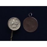 A United States gold One Dollar mounted on a stick pin and another USA gold coin mounted as a