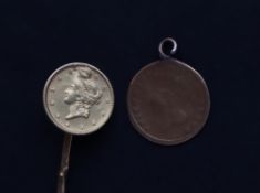 A United States gold One Dollar mounted on a stick pin and another USA gold coin mounted as a