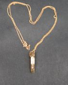 A 9ct yellow gold pendant set with seven round brilliant cut diamonds to a 9ct gold chain,