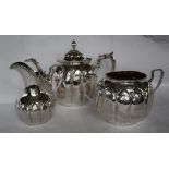 A Victorian silver three piece tea service, with lobed bodies and floral engraving,