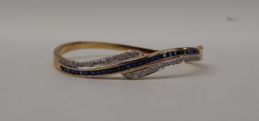 An 18ct gold sapphire and diamond hinged bangle,