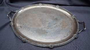 An Edwardian silver twin handled tray, of oval form, with a shell and gadrooned border, Sheffield,