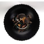 A Japanese lacquer plate, with a scalloped rim, decorated to the centre with a crane and a carp,