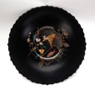 A Japanese lacquer plate, with a scalloped rim, decorated to the centre with a crane and a carp,