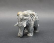 A jade carved elephant, in mottled grey and green, 8cm wide x 6.