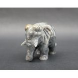 A jade carved elephant, in mottled grey and green, 8cm wide x 6.