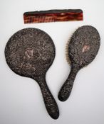 A George V silver backed hand mirror, brush, and comb, Birmingham,