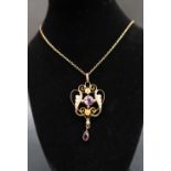 An Edwardian 9ct gold amethyst and seed pearl pendant of heart shape, on a 9ct gold chain,