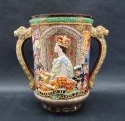 A Royal Doulton twin handled loving cup to celebrate the Silver Jubilee of her gracious Majesty