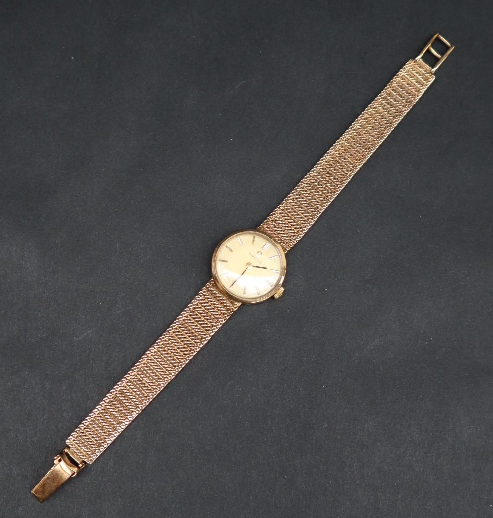 A lady's 9ct gold Omega wristwatch, the gilt dial with batons on an integral 9ct gold strap, - Image 3 of 6