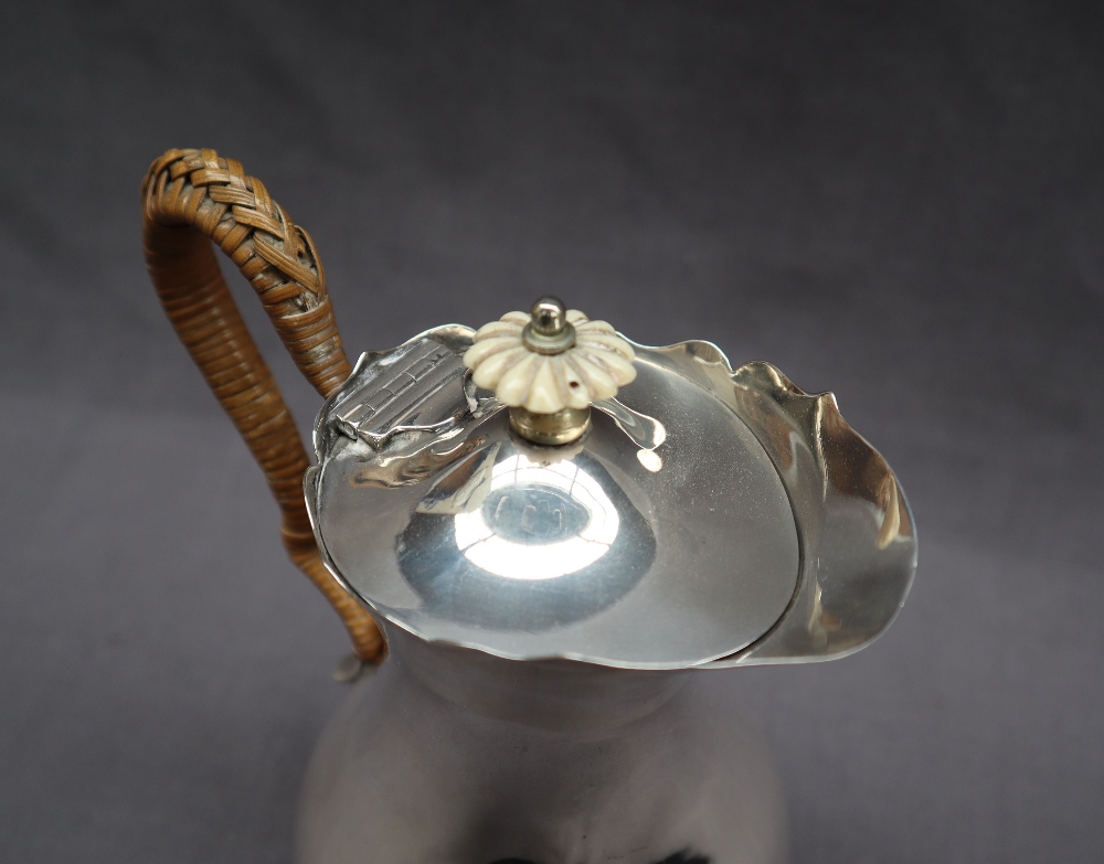 An Edward VII silver hot water jug with a flared edge and baluster body on three legs with trefid - Image 5 of 5