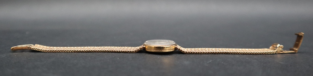 A lady's 9ct gold Omega wristwatch, the gilt dial with batons on an integral 9ct gold strap, - Image 6 of 6