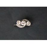 A three stone diamond ring, set with round brilliant cut diamonds,