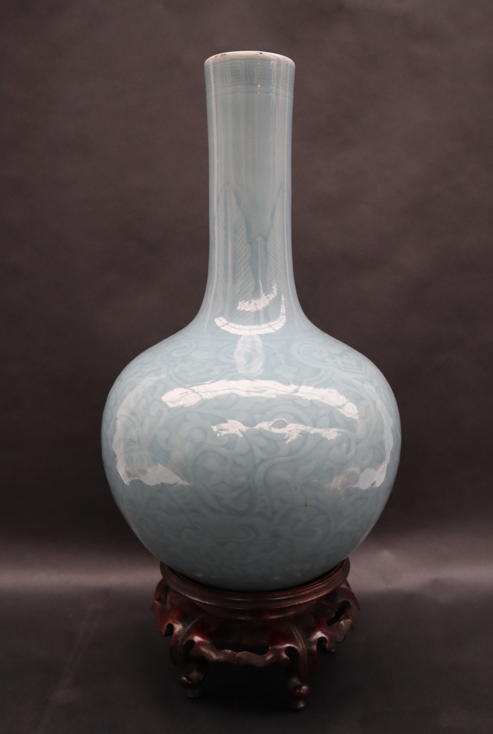 A 19th century Chinese blue Celadon bottle vase, decorated with scrolling leaves,