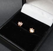 A pair of diamond stud earrings, each round brilliant cut diamonds approximately 0.