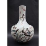 A Chinese porcelain bottle vase, decorated with magpies perched amongst a blossom tree,