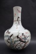 A Chinese porcelain bottle vase, decorated with magpies perched amongst a blossom tree,