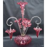 A Victorian cranberry glass epergne, with a central trumpet and three other trumpets,