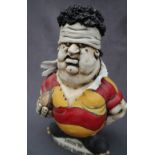 A John Hughes pottery Grogg of a Rugby player incised to the base "Golden Oldies Rugby Festival,