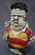 A John Hughes pottery Grogg of a Rugby player incised to the base "Golden Oldies Rugby Festival,