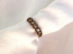 A diamond half eternity ring set with eight round brilliant cut diamonds to a white metal setting