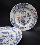 A pair of Chinese porcelain plates, decorated with deer amongst flowers and leaves,