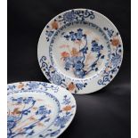 A pair of Chinese porcelain plates, decorated with deer amongst flowers and leaves,