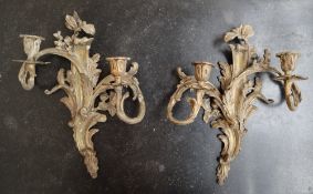 A pair of Rococo influenced ormolu wall sconces, each with two candle holders with leaf casting, 35.