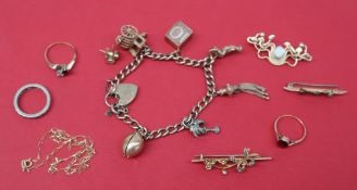 A 9ct yellow gold charm bracelet, set with numerous charms including a chick in an egg, carriage,